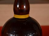 a bottle of liquor sitting on a table with a red table cloth