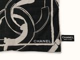 black and white image of a chanel scarf on a white background