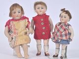 three dolls that are standing next to each other