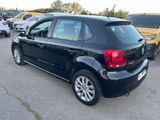 the back of a black volkswagen polo parked in a parking lot
