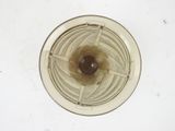 a brown substance inside of a blender on a white surface