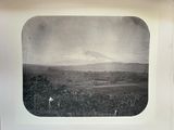 a black and white photo of a mountain in the distance