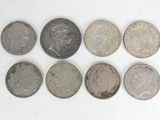 a close up of a group of coins on a white surface