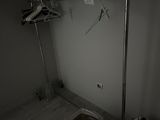 an image of a closet with clothes hanging on a rail