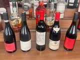 many bottles of wine sitting on a shelf in a bar