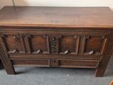 a wooden chest with a drawer on top of it