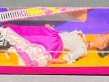 barbie doll in a pink box with a hair comb in it