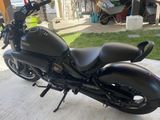 a black motorcycle that is parked in the driveway