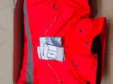 an image of a red jacket in a cardboard box on the floor