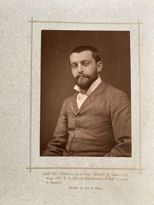 an old photo of a man with a beard in a suit and tie