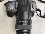 a camera that is sitting on a table with a strap around it
