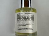 a close up of a bottle of liquid on a white surface