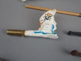 a small figurine of a man with a hat on a stick