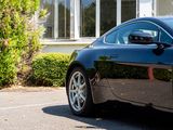 a black sports car parked in front of a house