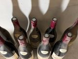 six bottles of wine are lined up in a row on a table