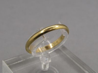 a gold ring sitting on top of a clear display case