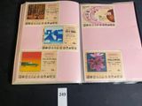 a picture of a pink book with stamps on it