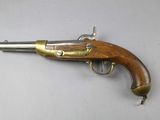 a close up of a gun on a table with a white background