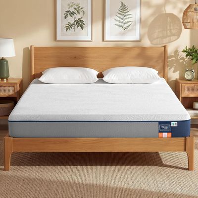 an image of a mattress in a bedroom with a wooden headboard