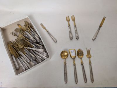 a box of silverware on a table with other silverware in it
