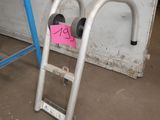 a ladder that has a sign on it in a room
