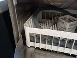 a dishwasher with a basket in it in a kitchen