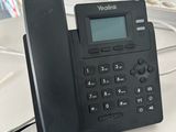 a telephone that is sitting on a desk next to a keyboard