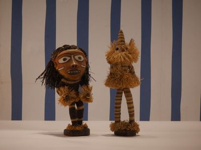 deux petites figurines en bois placées l'une à côté de l'autre