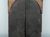 a small wooden cabinet with two doors on a table