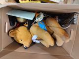 a cardboard box with stuffed animals inside of it