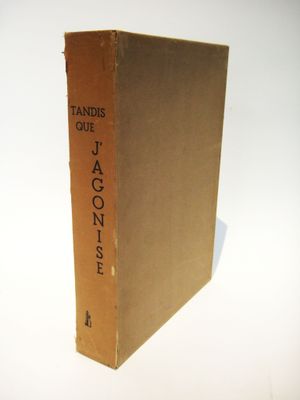 an old book sitting on top of a white table next to a white wall