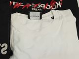 a black and white t - shirt and a pair of white pants
