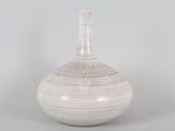 a white vase that is sitting on a table