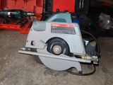 a circular saw sitting on the floor in a garage