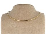 un gros plan sur un mannequin portant un collier en or