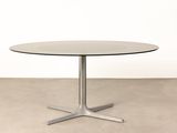 a round table with a metal base and a glass top