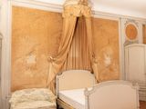 a bedroom with a bed, dressers, and a chair in it