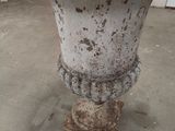 a white vase sitting on top of a cement table