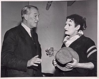 black and white photograph of a man and woman talking to each other