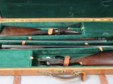 two shotguns in a case on a table