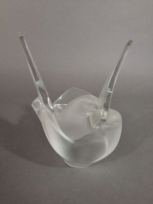 a clear glass bowl with a spoon sticking out of it
