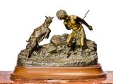 a bronze statue of a man and a dog on a rock