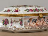 a white box with a painting on it sitting on a table