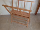 a wooden bench with a magazine rack on it