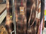 a lot of clothes hanging on a rack in a store