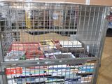 a metal cart with many items in it in a warehouse