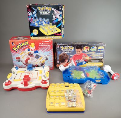 toys and games are sitting on a gray surface with a gray background