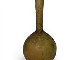a green glass vase with a floral design on it