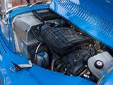 a close up of a blue car with a engine in it