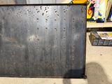 a metal box with holes in it sitting on the floor